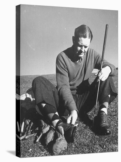 Golfer Byron Nelson Cleaning the Cleats on His Shoes-Gabriel Benzur-Stretched Canvas