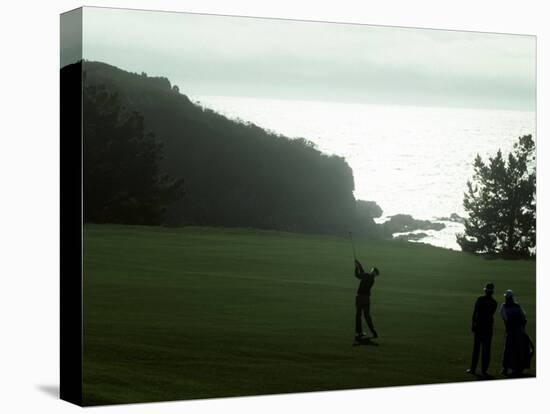 Golfer in Action with Water View Beyond-null-Stretched Canvas