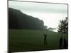 Golfer in Action with Water View Beyond-null-Mounted Photographic Print