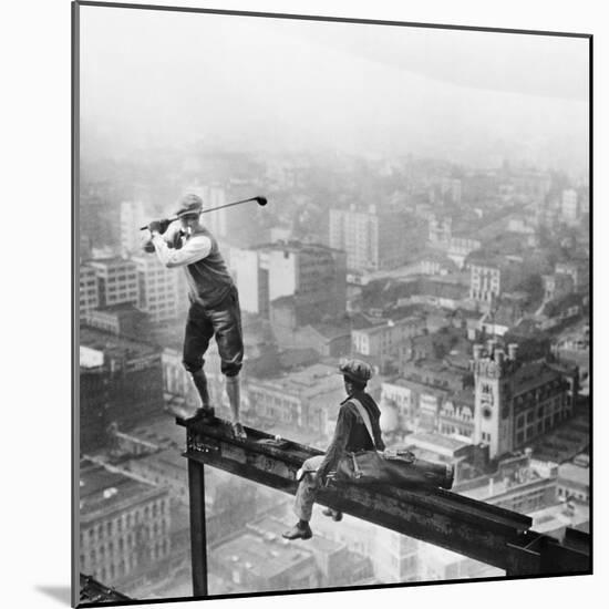 Golfer Teeing off on Girder High above City-null-Mounted Premium Photographic Print