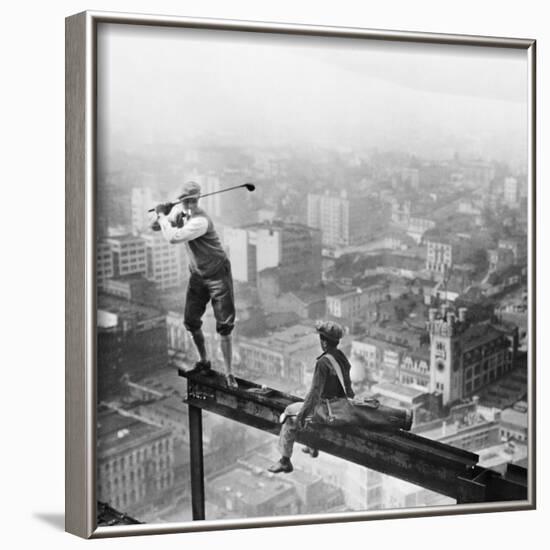 Golfer Teeing off on Girder High above City-null-Framed Photographic Print