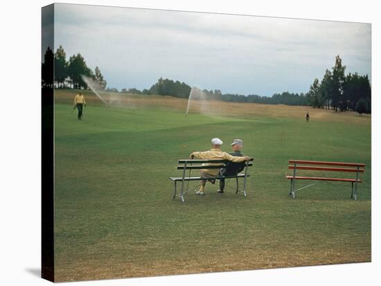 Golfers Sitting on Bench Near Practice Greens While Awaiting Tee Time on Pinehurst Golf Course-Walker Evans-Stretched Canvas