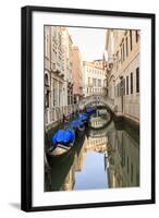 Gondola Parking under Bridge. Venice. Italy-Tom Norring-Framed Photographic Print