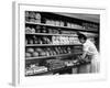 Good of Worker in Bakery Standing in Front of Shelves of Various Kinds of Breads and Rolls-Alfred Eisenstaedt-Framed Photographic Print