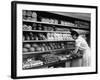 Good of Worker in Bakery Standing in Front of Shelves of Various Kinds of Breads and Rolls-Alfred Eisenstaedt-Framed Photographic Print