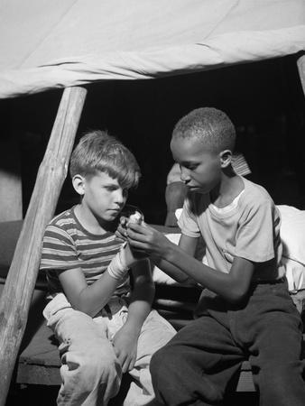 African American Camper Helps a White Bubby with His Bandaged Hand