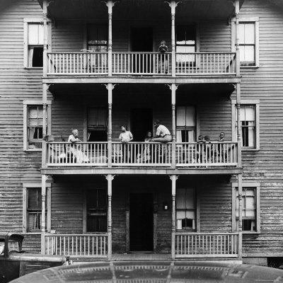 Family on Balcony of Apartment Building