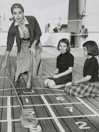 https://imgc.allpostersimages.com/img/posters/grace-kelly-by-playing-shuffleboard-on-the-deck-of-the-uss-constitution-april-10-1956_u-L-Q10WSD40.jpg?artPerspective=n