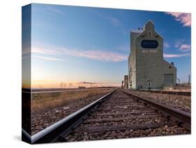 Grain elevator and railroad track, Milk River, Alberta, Canada-null-Stretched Canvas