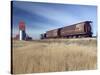 Grain Elevators and Wheat Train, Saskatchewan, Canada-Walter Bibikow-Stretched Canvas