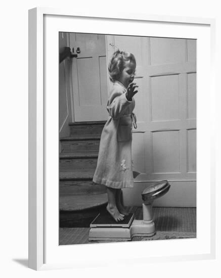 Grand Daughter of Winston Churchill, Arabella Spencer Churchill, Jouncing on Bathroom Scale-Carl Mydans-Framed Premium Photographic Print