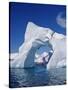 Grandidier Channel, Tourists Zodiac Cruising by Arched Iceberg Near Booth Island, Antarctica-Allan White-Stretched Canvas