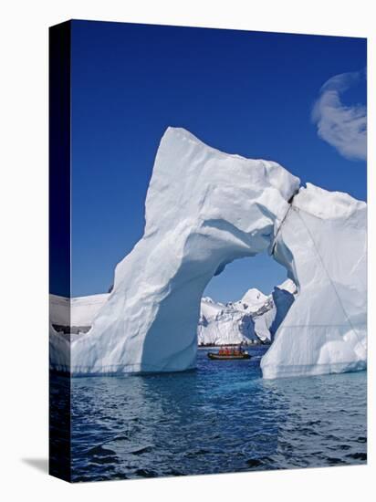Grandidier Channel, Tourists Zodiac Cruising by Arched Iceberg Near Booth Island, Antarctica-Allan White-Stretched Canvas