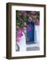 Greece, Santorini. A picturesque blue door is surrounded by pink bougainvillea in Firostefani.-Brenda Tharp-Framed Photographic Print