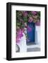 Greece, Santorini. A picturesque blue door is surrounded by pink bougainvillea in Firostefani.-Brenda Tharp-Framed Photographic Print