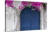 Greece, Santorini. Weathered blue door is framed by bright pink Bougainvillea blossoms.-Brenda Tharp-Stretched Canvas