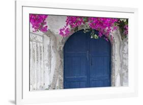 Greece, Santorini. Weathered blue door is framed by bright pink Bougainvillea blossoms.-Brenda Tharp-Framed Photographic Print