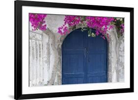 Greece, Santorini. Weathered blue door is framed by bright pink Bougainvillea blossoms.-Brenda Tharp-Framed Photographic Print