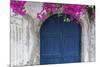 Greece, Santorini. Weathered blue door is framed by bright pink Bougainvillea blossoms.-Brenda Tharp-Mounted Photographic Print