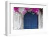 Greece, Santorini. Weathered blue door is framed by bright pink Bougainvillea blossoms.-Brenda Tharp-Framed Photographic Print