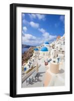 Greek Church with Three Blue Domes in the Village of Oia-Neale Clark-Framed Photographic Print