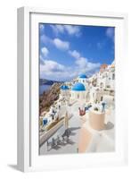 Greek Church with Three Blue Domes in the Village of Oia-Neale Clark-Framed Photographic Print