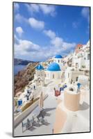 Greek Church with Three Blue Domes in the Village of Oia-Neale Clark-Mounted Photographic Print