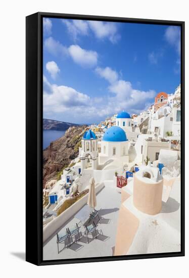 Greek Church with Three Blue Domes in the Village of Oia-Neale Clark-Framed Stretched Canvas