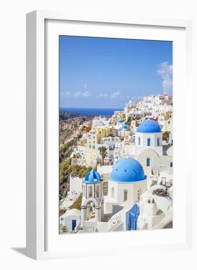 Greek Church with Three Blue Domes in the Village of Oia-Neale Clark-Framed Photographic Print