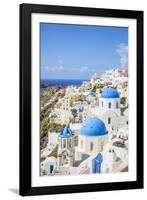 Greek Church with Three Blue Domes in the Village of Oia-Neale Clark-Framed Photographic Print