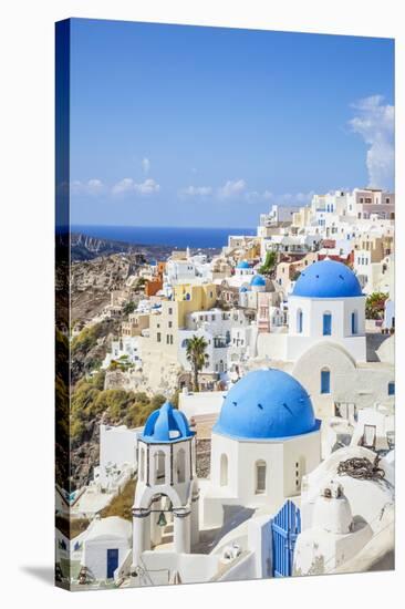 Greek Church with Three Blue Domes in the Village of Oia-Neale Clark-Stretched Canvas