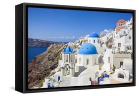 Greek Church with Three Blue Domes in the Village of Oia-Neale Clark-Framed Stretched Canvas