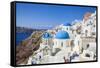 Greek Church with Three Blue Domes in the Village of Oia-Neale Clark-Framed Stretched Canvas