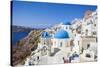 Greek Church with Three Blue Domes in the Village of Oia-Neale Clark-Stretched Canvas