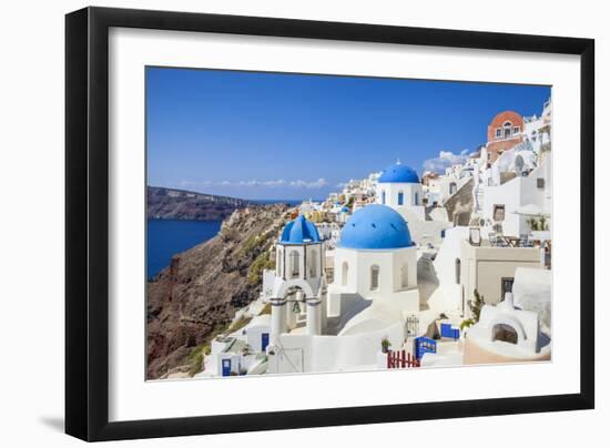 Greek Church with Three Blue Domes in the Village of Oia-Neale Clark-Framed Photographic Print