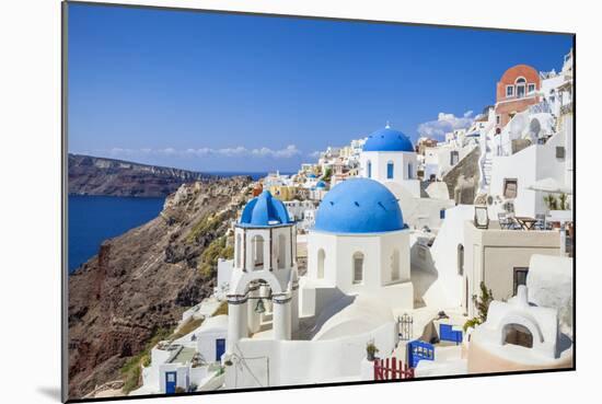 Greek Church with Three Blue Domes in the Village of Oia-Neale Clark-Mounted Photographic Print