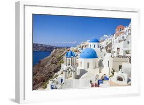 Greek Church with Three Blue Domes in the Village of Oia-Neale Clark-Framed Photographic Print