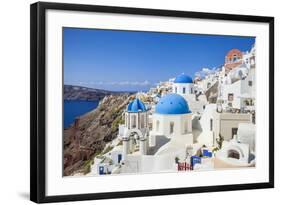 Greek Church with Three Blue Domes in the Village of Oia-Neale Clark-Framed Photographic Print