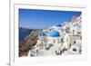 Greek Church with Three Blue Domes in the Village of Oia-Neale Clark-Framed Photographic Print