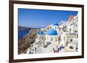 Greek Church with Three Blue Domes in the Village of Oia-Neale Clark-Framed Photographic Print