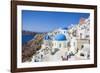 Greek Church with Three Blue Domes in the Village of Oia-Neale Clark-Framed Photographic Print