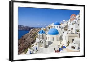 Greek Church with Three Blue Domes in the Village of Oia-Neale Clark-Framed Photographic Print