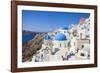 Greek Church with Three Blue Domes in the Village of Oia-Neale Clark-Framed Photographic Print