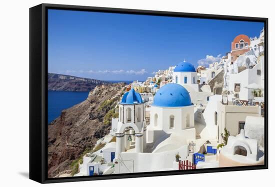 Greek Church with Three Blue Domes in the Village of Oia-Neale Clark-Framed Stretched Canvas