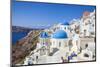 Greek Church with Three Blue Domes in the Village of Oia-Neale Clark-Mounted Premium Photographic Print