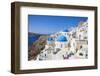 Greek Church with Three Blue Domes in the Village of Oia-Neale Clark-Framed Photographic Print