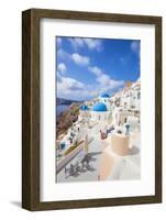 Greek Church with Three Blue Domes in the Village of Oia-Neale Clark-Framed Photographic Print