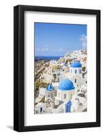 Greek Church with Three Blue Domes in the Village of Oia-Neale Clark-Framed Photographic Print