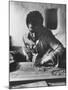 Greek Mountain Villager Engaged in Woodworking During the Winter-James Burke-Mounted Photographic Print