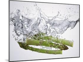 Green Asparagus Falling into Water-Kröger & Gross-Mounted Photographic Print